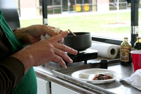 Russell Gwatney of Gwatney Chevrolet wipes his hands after preparing a sauce for the meat that he and his are team cooking.  The men of Gwatney Chevrolet prepared a wonderful barbeque lunch for Union University faculty, staff, and students.
