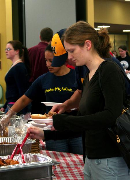 Mary Olson, sophomore teaching English as a second language major, gets her barbeque plate at the lunch provided and prepared by the team at Gwatney Chevrolet.  Gwatney Chevrolet's barbeque placed first at Memphis in May 2005.