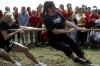 Bethany Anderson and Missy Ratliff pull with all their strength to win the tug-of-war competition while their Chi Omega sisters cheer for them. - Photo by Kyle Kurlick
