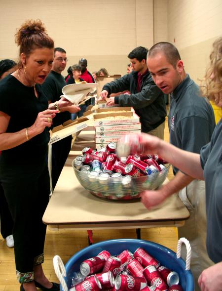 Mark Mogle helps serve pizza with his fellow SIFE members.  SIFE directed games, projects, and lunch for kids and teachers in the local area.  