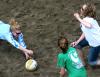 Bekah Long, senior psychology major, dives for the ball while her teammates run to help her during the volleyball tournament that helped raise money for the disaster relief fund. - Photo by Kristi McMurry