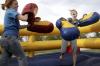 Kinsey Bolinger and Emily Watlington enjoy May Day by boxing in the inflatable ring set up for students. - Photo by Kyle Kurlick