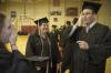 Music Graduate Austin Clark lightens the mood by telling a joke to fellow music majors Bethany Jenkins and Leandra Brown as they line up for the spring graduation ceremony. - Photo by Jordan Buie
