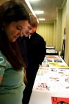 Kat Douglas, senior art major, and Alan Knox, senior DMS major, look at the graphic design work of people in the area at the annual Addy awards.  Both students won awards at this event. - Photo by Kristi McMurry