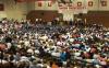 Graduates file across the stage in the Fred DeLay gymnasium during summer graduation. - Photo by Angela Abbamonte
