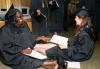 Organizational leadership graduates, Cassandra Hunt and Angela Tharpe, have a laugh before the graduation ceremony begins. - Photo by Kristi McMurry