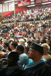 Ronnie Smith, receiving his masters in Christian studies, and Tracy Brittmon, receiving her doctorate of education, listen to President Dockery's commencement charge about hope at summer graduation. - Photo by Kristi McMurry