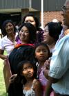 May Lee Almeria, who received her masters in nursing, spends time with her family from Tampa, Florida after the summer graduation ceremony. - Photo by Kristi McMurry
