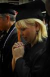 Doris Simas, of Jackson, Tenn., prays just before receiving her Bachelor of Science in Nursing degree during the summer graduation at Union University.  - Photo by Jim Veneman
