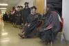 Kiva Mallory (2nd from right) and Tameka Anderson (far right) talk while waiting to go into the Fred DeLay Gymnasium for graduation.  Mallory and Anderson are both graduating with a Master of Education. - Photo by Justin Veneman
