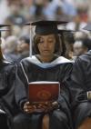 Monique Thomas reads her program during Union's summer graduation ceremony at the Fred DeLay Gymnasium. Thomas is graduating as a Education Specialist. - Photo by Justin Veneman