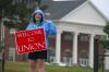 Catherine Neal, senior intercultural studies major, welcomes new students and their families to Union at the front entrance.   - Photo by Kristi McMurry