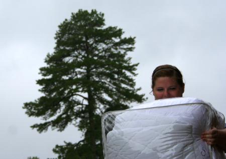 Katy Pope, junior art major, carries a comforter through the rain on the day that Union's newest students moved into the residence life complex.