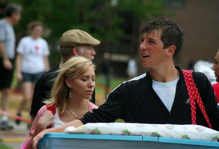 Margaret Brenson and Jay Landham carry things into the dorm rooms during move-in day for new students.