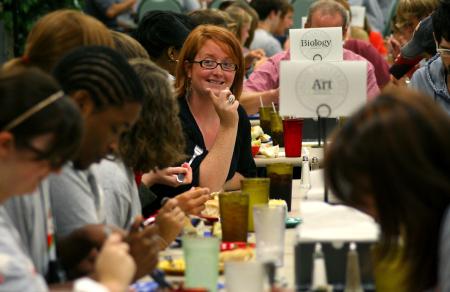 Kathleen Murray, photography instructor, talks with new art students at the dinner with your department event during new student orientation.