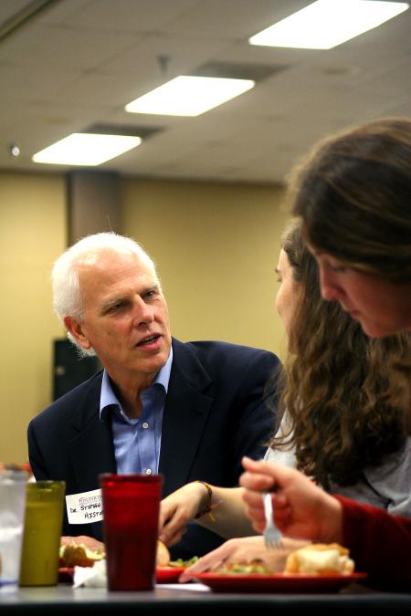 Stephen Carls, chair of the department of history, talks with Julianne Little and Megan Winters at the dinner with your department event during new student orientation.