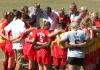 Head Coach Brandon Boylan leads his team in a pre-game prayer. - Photo by Steven Aldridge