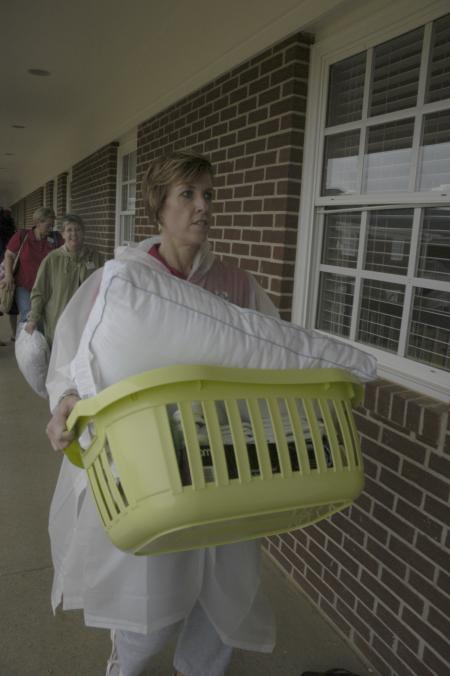 Nursing faculty members Tracy Saddler, Jill Webb and Sandra Brown help freshmen move into the new residence complex.