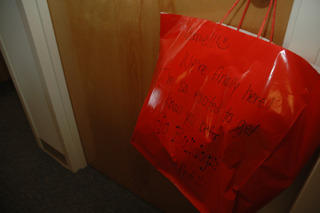 Freshman Andy Schreiber hangs a welcoming gift on her new roommate's door.