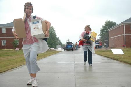 Nursing faculty members Tracy Saddler and Rosemary McLaughlin stuck through the rain and mud to help frehsmen and transfer students move into their new homes. 