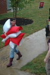 Through the rain and mud, volunteers are still joyful and able to help speed the process of Freshman move-in. - Photo by Beth Spain