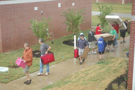 A steady stream of volunteers helped new students move their belongings into the new residence life complex.