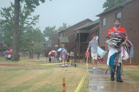 Senior Kieler Henry carries a load of clothes to a girl's dorm during Freshmen move-in day. 