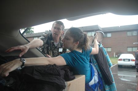 Richard Wells, dean of the chapel, and Erica Tuns, MIR, help unload a freshman car.