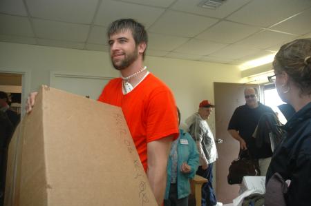 Senior Kieler Henry carries boxes of freshmen belongings during move-in day.