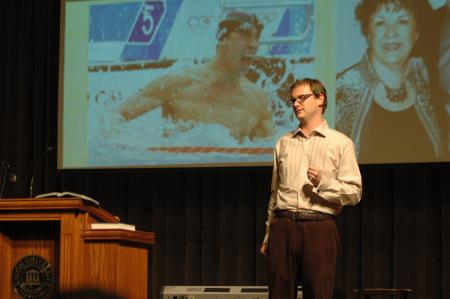 Greg Thornbury, dean of the School of Christian Studies, speaks about Michael Phelps and his mother during the New Student Orientation worship service.