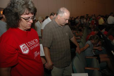 Parents circle around their students to pray over them before leaving them in the care of the Union family.