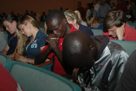 New Union students are lead in a prayer by President Dockery during the Focus evening worship service. 