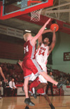 Senior Derrick Underwood gets a burst of energy as he shoots for two over an opposing Lyon. - Photo by Lindsay Stavish
