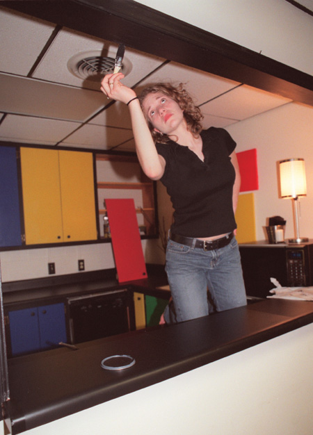 Assignment: Trading Spaces - Junior Emily Jonas, English major, puts the finishing touches on the kitchen in Watters Commons.