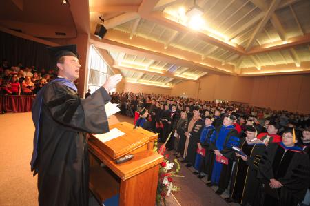 Christopher Mathews, new chair of the music department, leads the music during the fall convocation service.