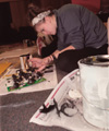 Assignment: Trading Spaces - Sophomore Leah Taylor, social work major, has the detailed job of painting cabinet handles. - Photo by Kristen Hiller