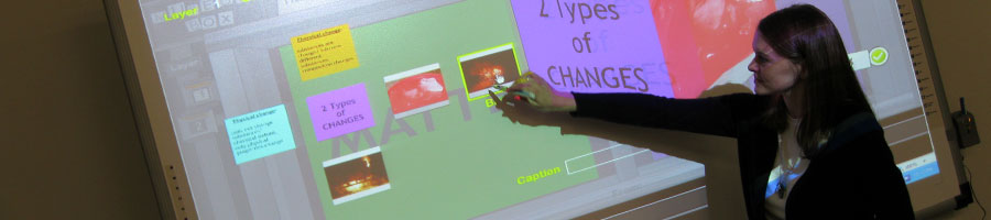 A student uses the Smart Board for a presentation.