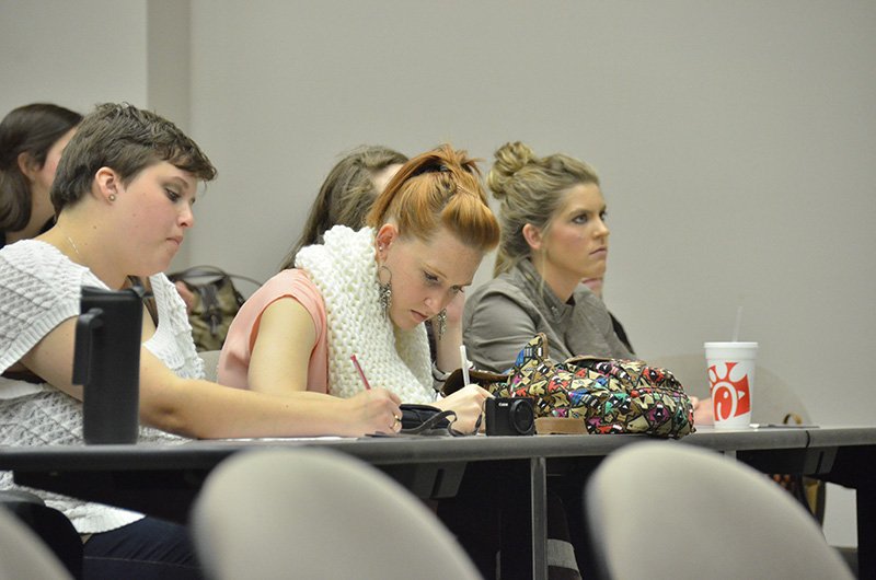 S.I.S. officers McKenzie Lynn, Kelsey Queen, and Shelby Henson listen and take notes as Phil Davignon discusses the redemption of sociology.