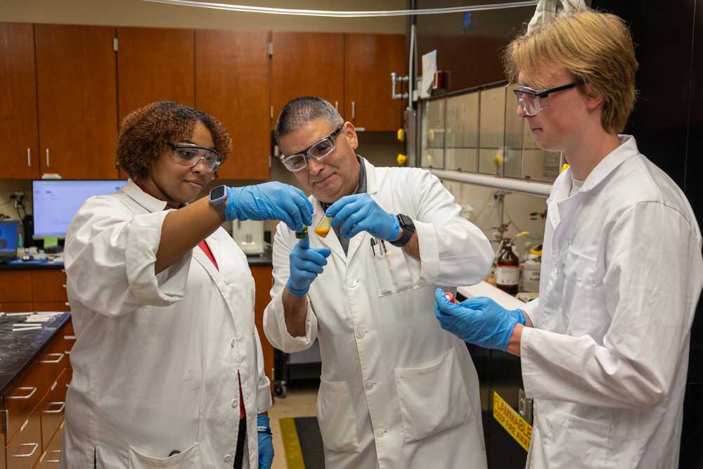 Blake Watkins conducts research with students