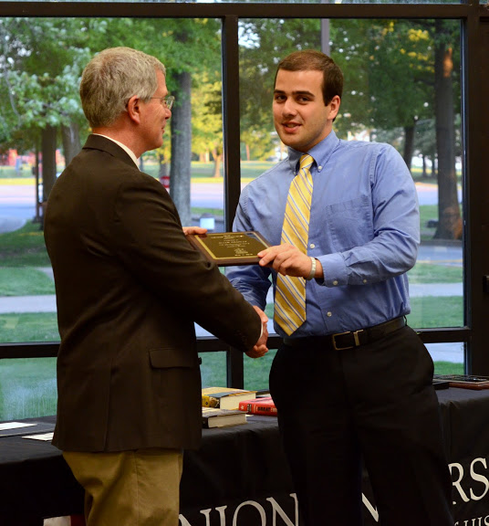 Dr. David Thomas (left) congratulates Allen Bradley at the history awards banquet on May 5, 2016, as he presents him with a History Minor Award. Photo by MiKalla Cotton