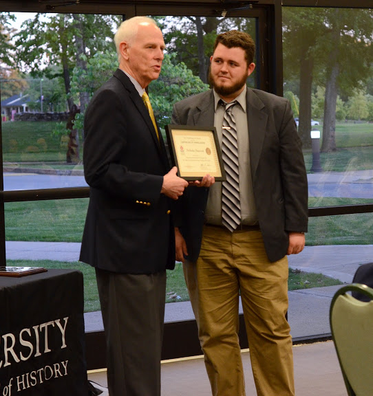 Dr. Stephen Carls (left) presents a certificate of appreciation to Nicholas Hancock at the history awards banquet on May 5, 2016, for his work as president of Phi Alpha Theta in 2015-2016. Photo by MiKalla Cotton