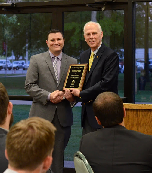 Dr. Stephen Carls (right) presents the History Alumni Distinguished Achievement Award to J. Jason Williams at the history awards banquet on May 5, 2016. Photo by MiKalla Cotton