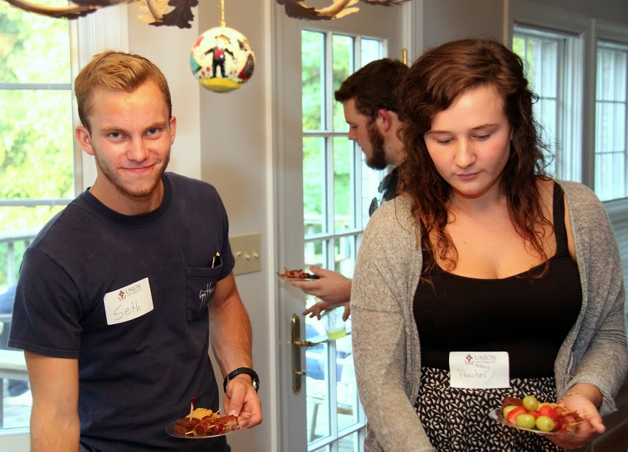 Union students Seth Reid and Abbey Peecher pick out treats at the History Welcome Reception on August 31, 2015. History major Nick Hancock is behind them.