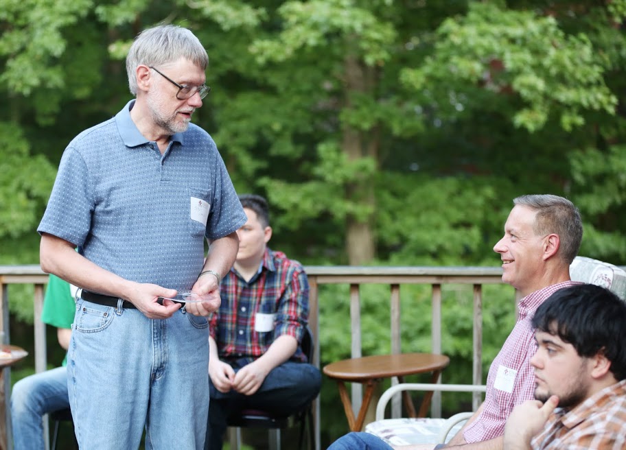 Dr. Terry Lindley (standing) talks to Dr. Henry Allen at the History Welcome Reception on August 31, 2015. History major Ashton Hostetler is in the lower right hand corner of the photo.