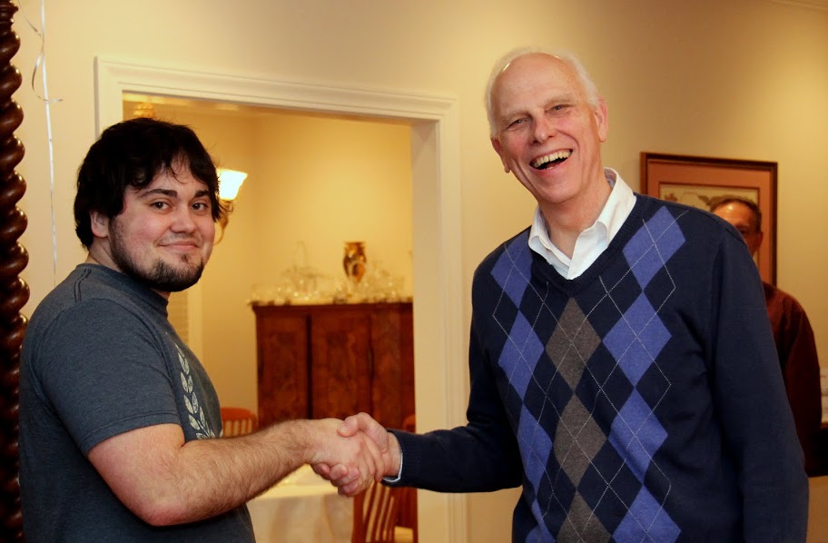 Dr. Stephen Carls (right) congratulates Ashton Hostetler on December 5, 2015, on his upcoming graduation from Union University with a bachelor's degree in history.