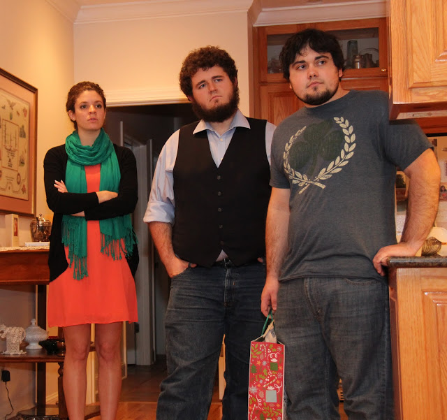 Attendees at the Franco-American Christmas dinner on December 5, 2015, listen to Allen Bradley play a Christmas carol on his shuttle pipes. They are (left to right) Karis Lancaster, Nicholas Hancock, and Ashton Hostetler.