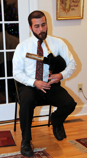 Allen Bradley plays a Scottish tune on his shuttle pipes at the Franco-American Christmas dinner on December 5, 2015.