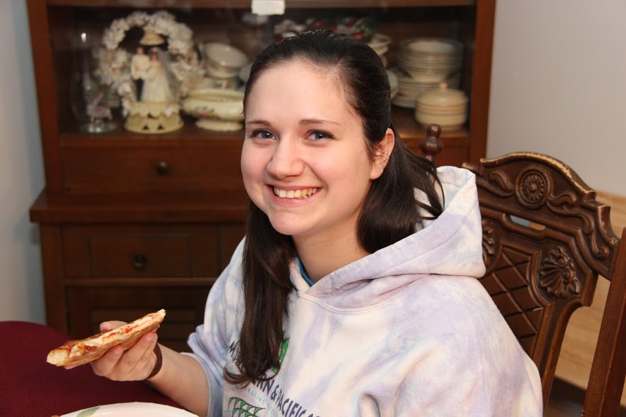 Lydia Black enjoys pizza at the Rutledge Honorary History Club's fall pizza party at Dr. Terry Lindley's home on November 19, 2015.