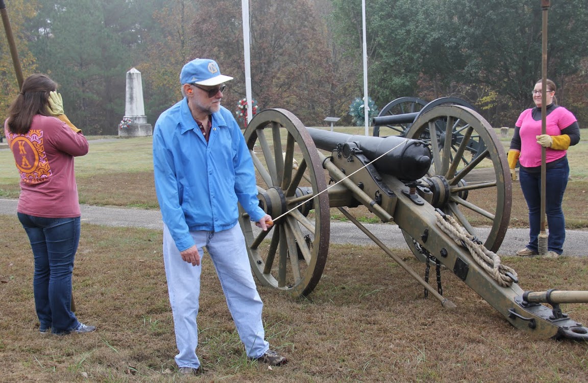 Dr. Terry Lindley prepares to pull the lanyard (trigger cord) for a cannon firing at Britton Lane Battlefield on November 3, 2015. Jordan Sellers (back to camera) and Hannah Conway (right) wait with anticipation.