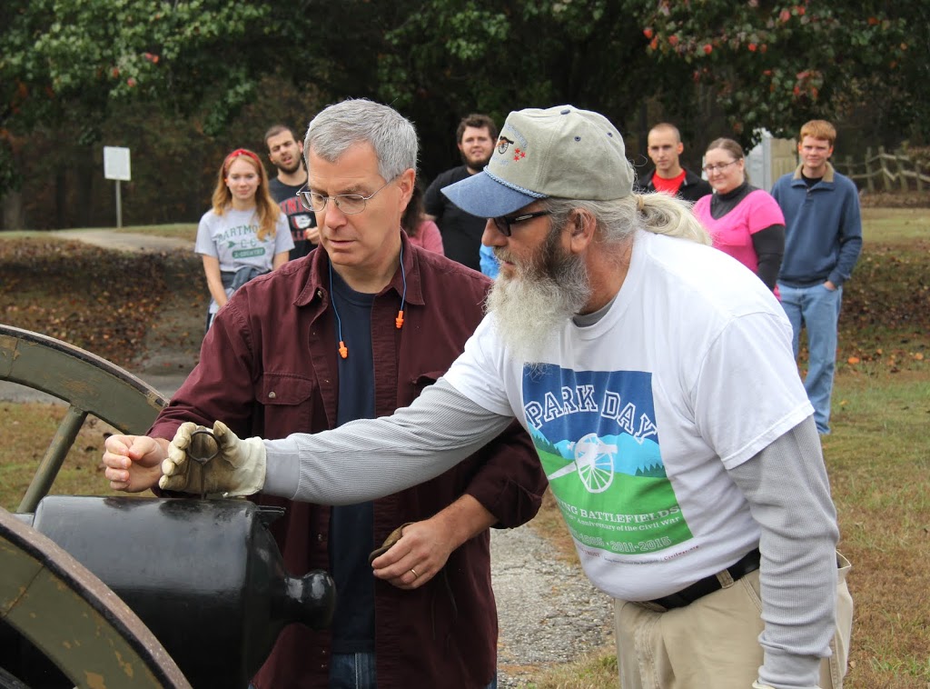 James Price of the Britton Lane Battlefield Association shows Dr. David Thomas how to use a priming wire in preparing a cannon for firing on November 3, 2015.